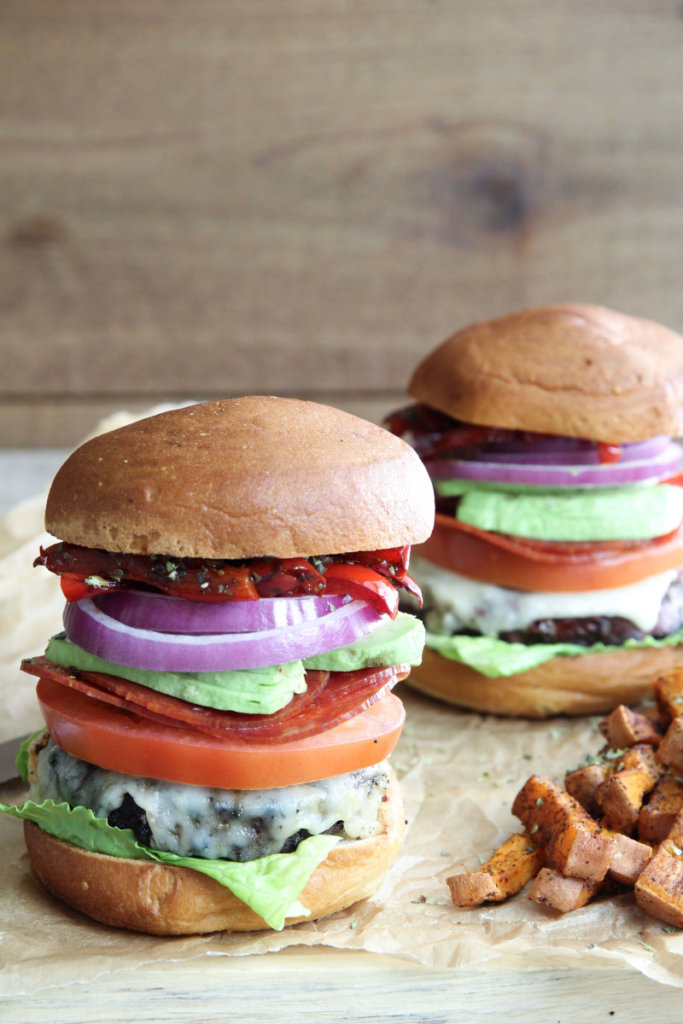 A mouthwatering grass-fed Italian Club Burger topped with goat cheddar, balsamic peppers, lettuce, onion, tomato and avocado: Jessi's Kitchen