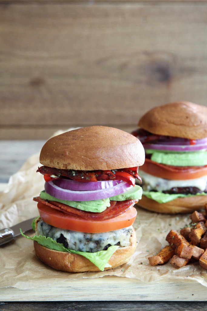 A mouthwatering grass-fed Italian Club Burger topped with goat cheddar, balsamic peppers, lettuce, onion, tomato and avocado: Jessi's Kitchen